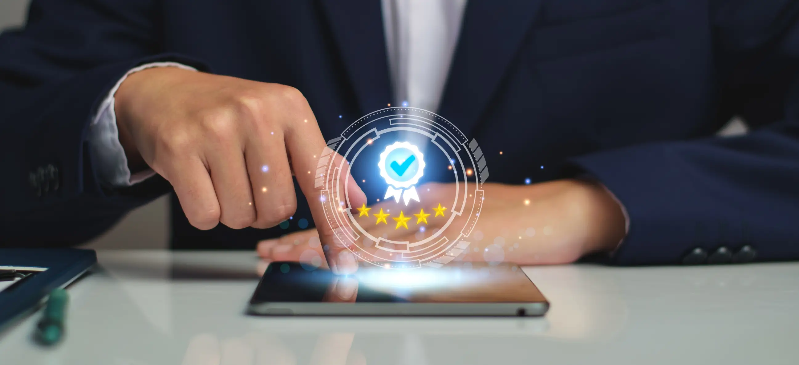 A business professional in a suit interacting with a tablet, displaying a digital badge icon with a checkmark and five stars, symbolizing quality assurance. The image visually represents the concept of ISO certification in UAE, highlighting modern digital solutions and professional standards compliance.