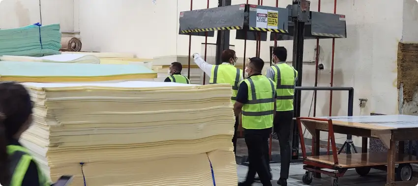 ISO 14001 environmental management practices in UAE manufacturing facility with safety-compliant workforce